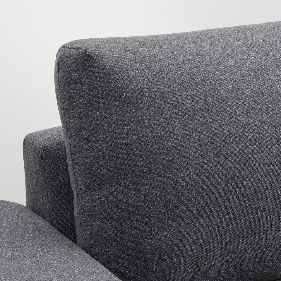 Close-up of VIMLE sofas plush, inviting, grey fabric. Soft texture, quality upholstery evident.