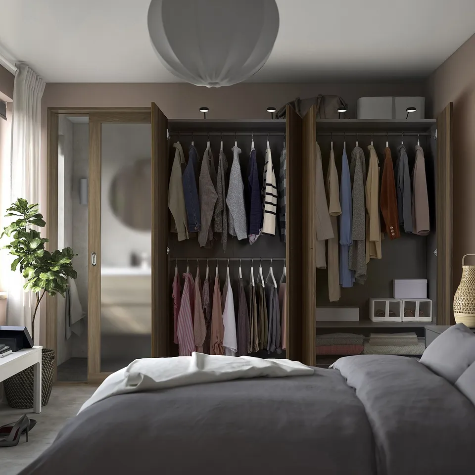 Modern bedroom with PAX wardrobe, lights, and grey bed.