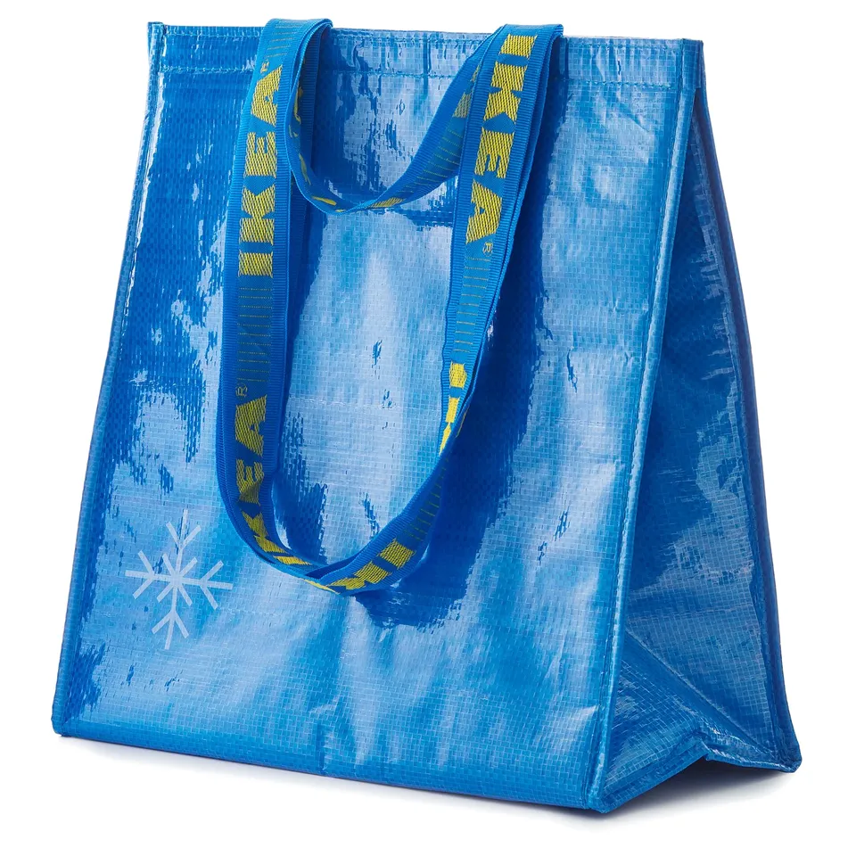 Blue reusable bag with yellow straps, snowflake design, rectangular shape, made from recycled materials.