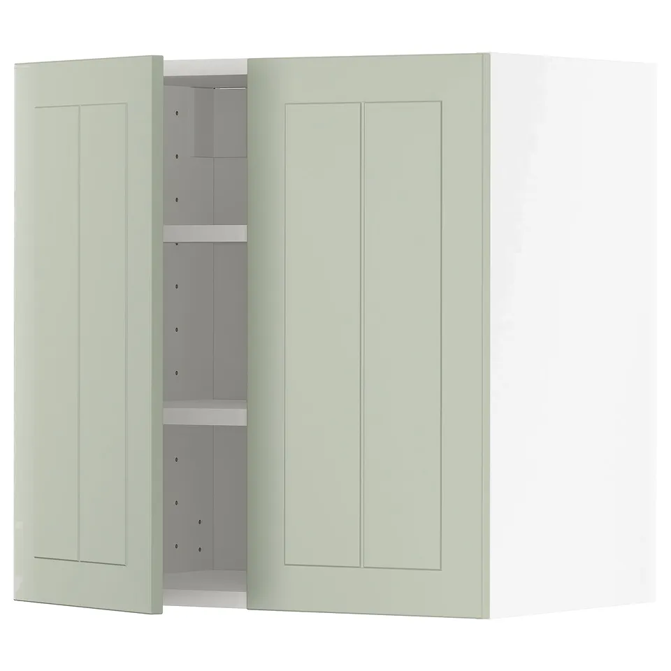 A light green METOD kitchen cabinet with two doors and adjustable shelves, set against a white background.