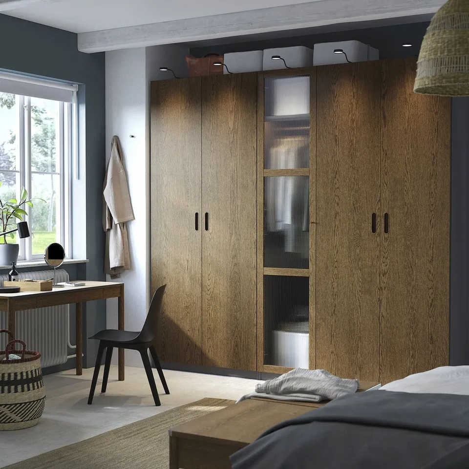 Bedroom with PAX wardrobes, chair, desk, plant.