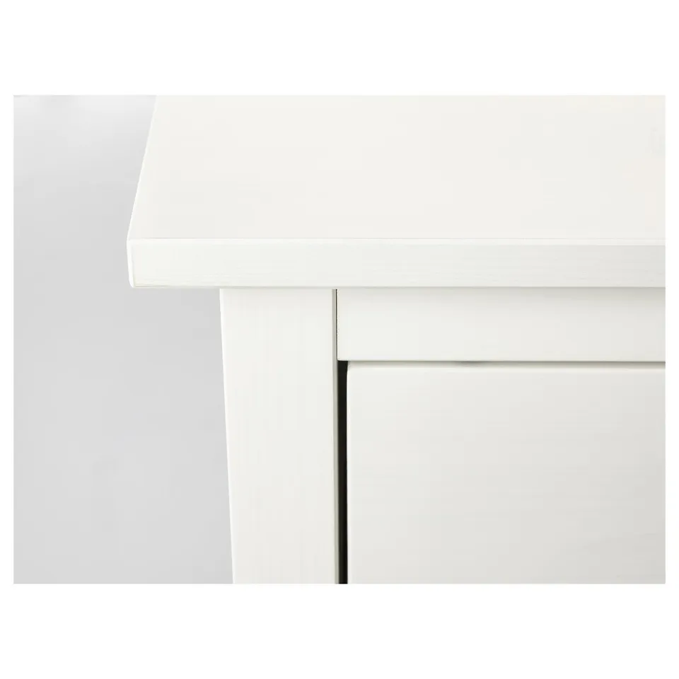 Modern white wood chest with smooth drawers.