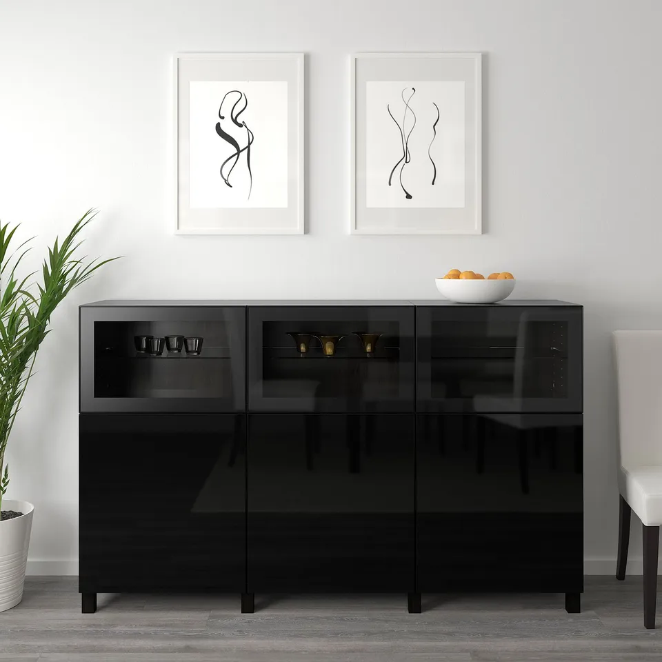 Black glass display sideboard with adjustable shelves, soft-closing doors, and wall-mounted art.