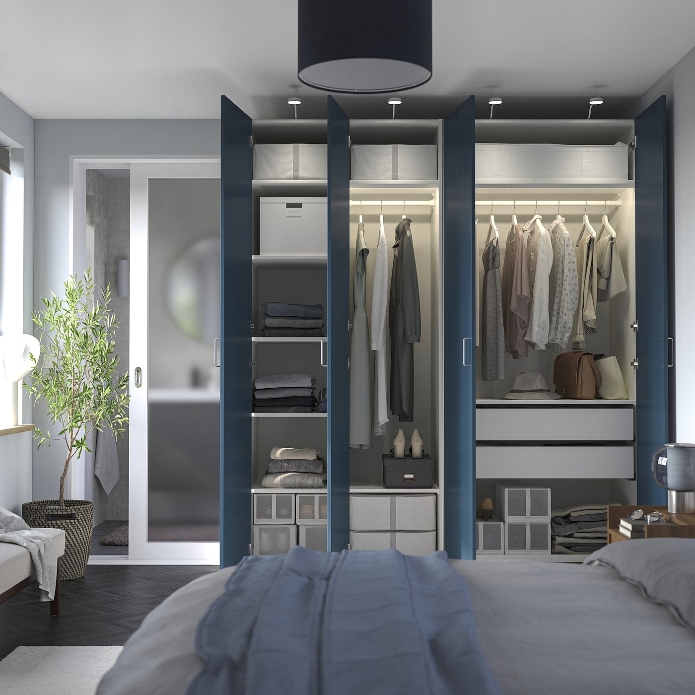 Modern bedroom with a PAX wardrobe displaying grey clothes, folded towels, and exterior lighting.
