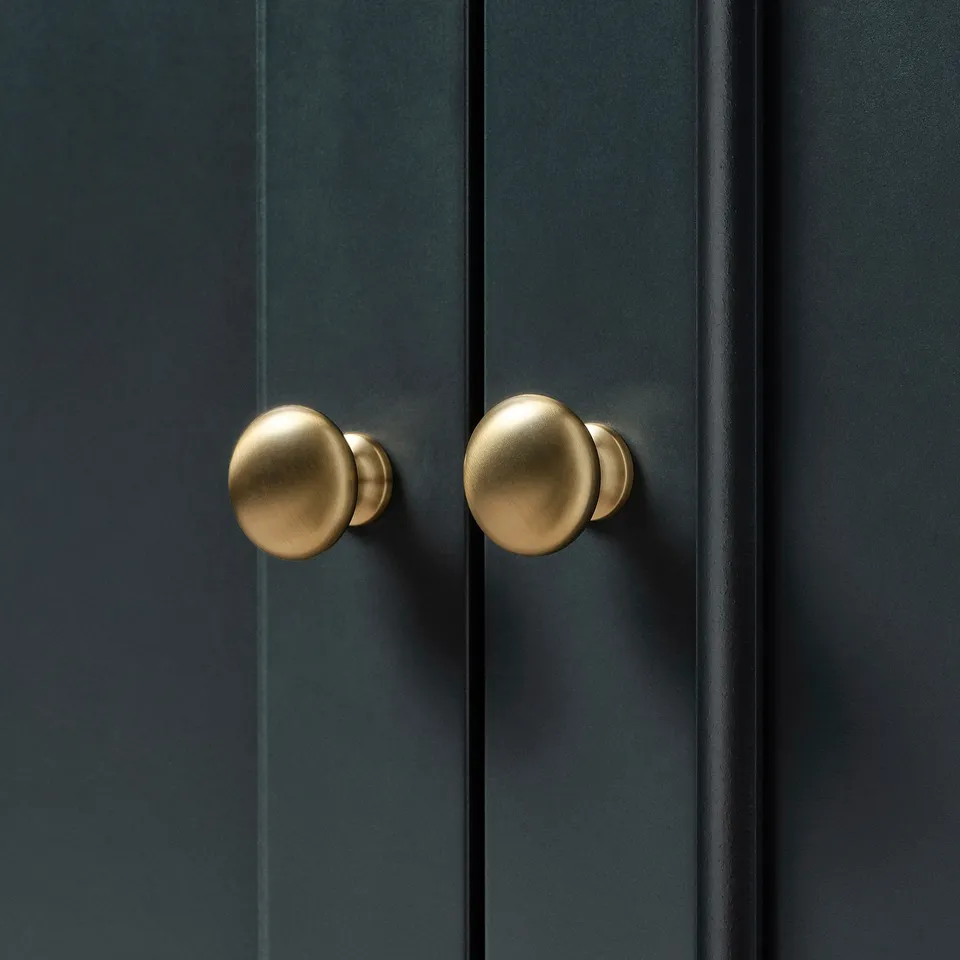 Dark green cabinet with two sleek gold-colored knobs, showcasing modern design and quality craftsmanship.