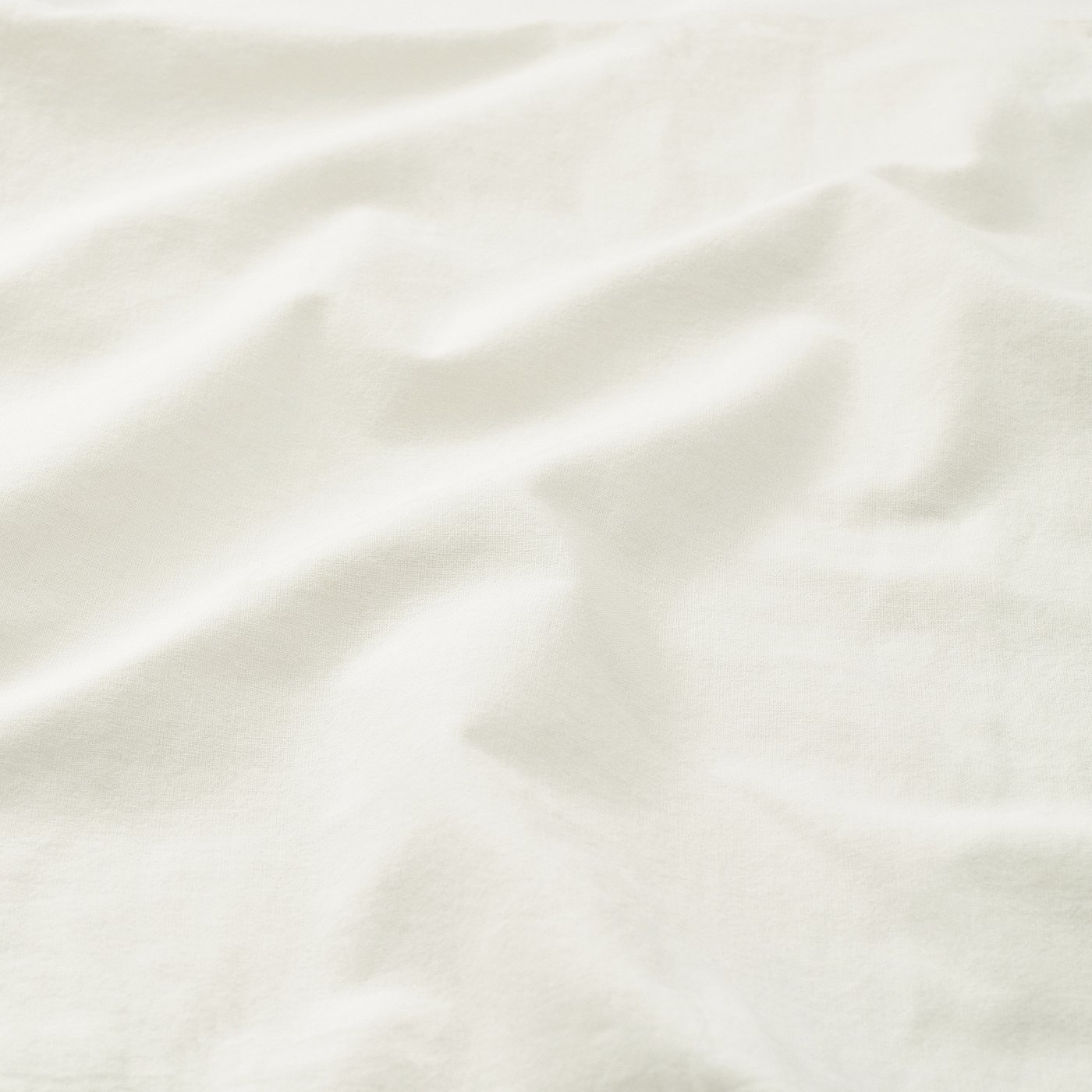 Soft, white cotton fabric close-up, showcasing fine weave and texture, indicating quality and comfort.