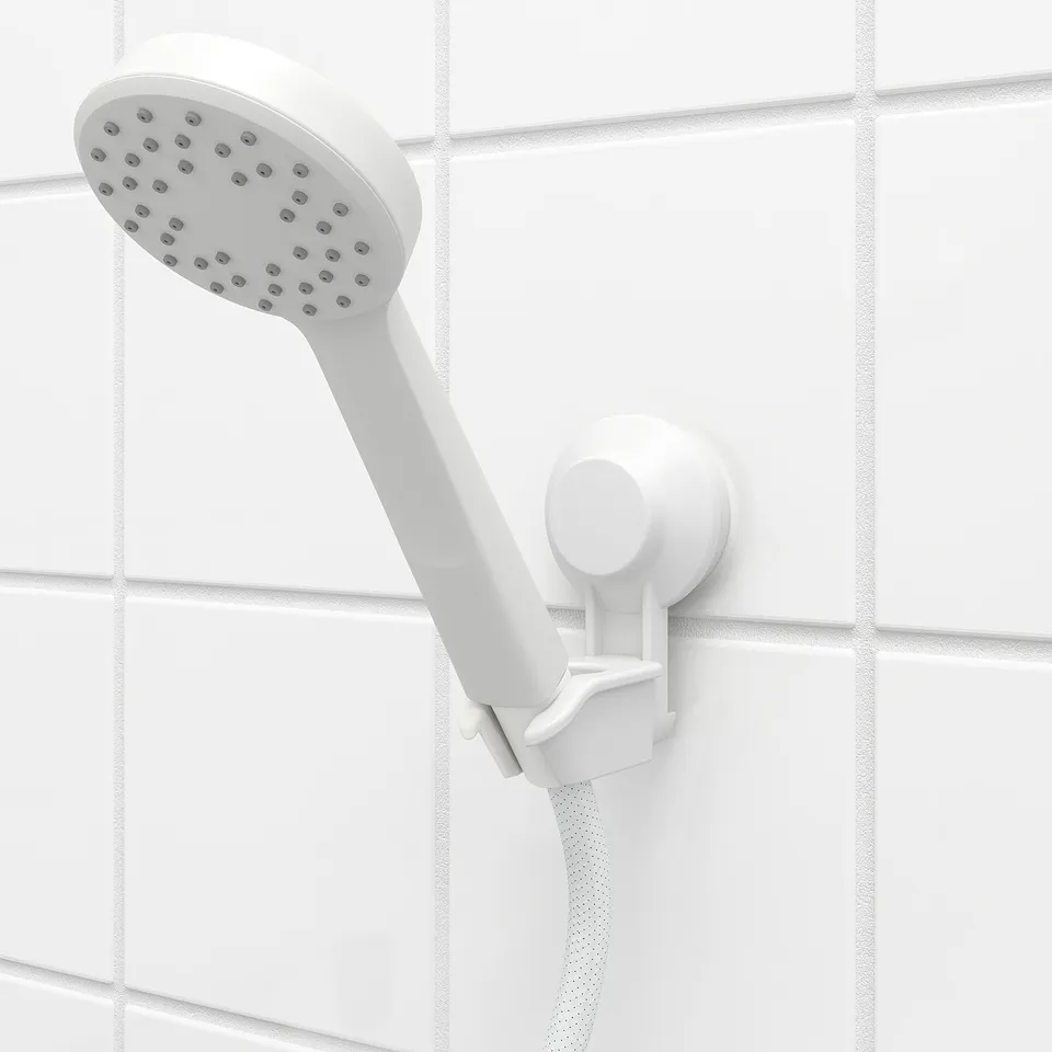 White shower head on white tiled wall, attached by suction cup, adjustable holder.