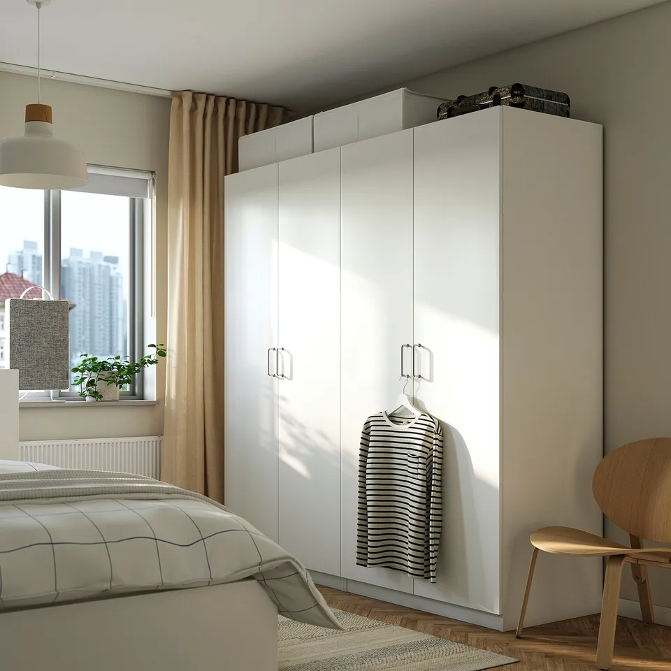 Modern bedroom with large PAX wardrobe, striped shirt, grey bed, wooden chair, pendant lamp, and city view.