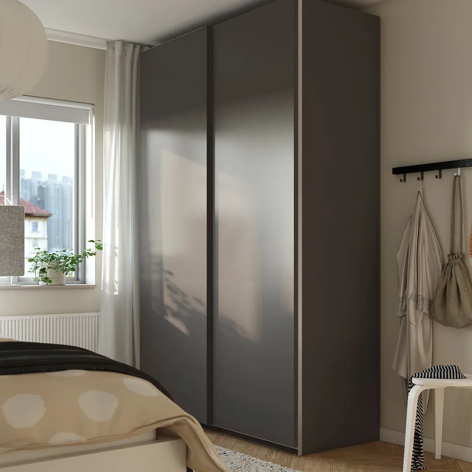 Modern bedroom with PAX wardrobe, hooks for coats, plant, polka-dot bed.