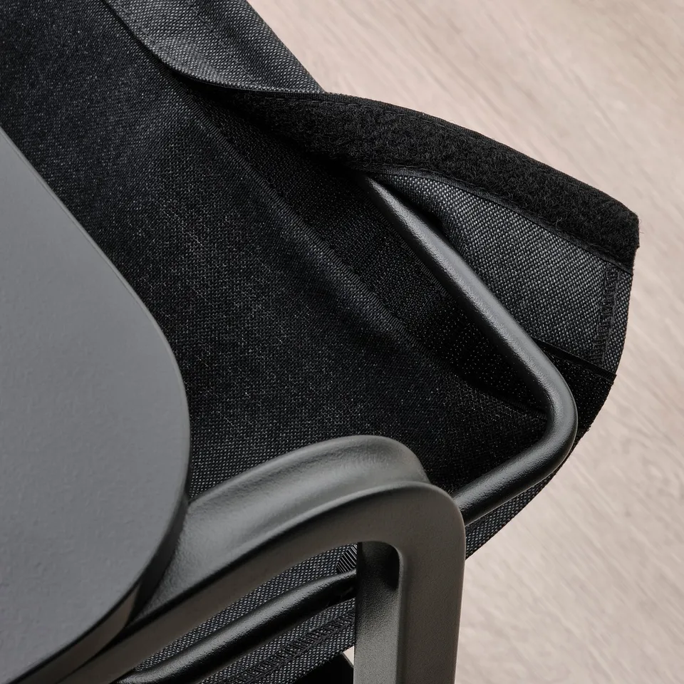 Close-up of OLSERÖD tables adjustable design, showing fabric pouch for storage under removable table top.