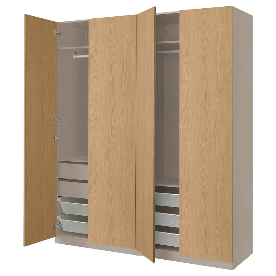 An open wooden PAX wardrobe. Its light honey colour drawers and shelves inside. It includes a mesh basket and adjustable feet.