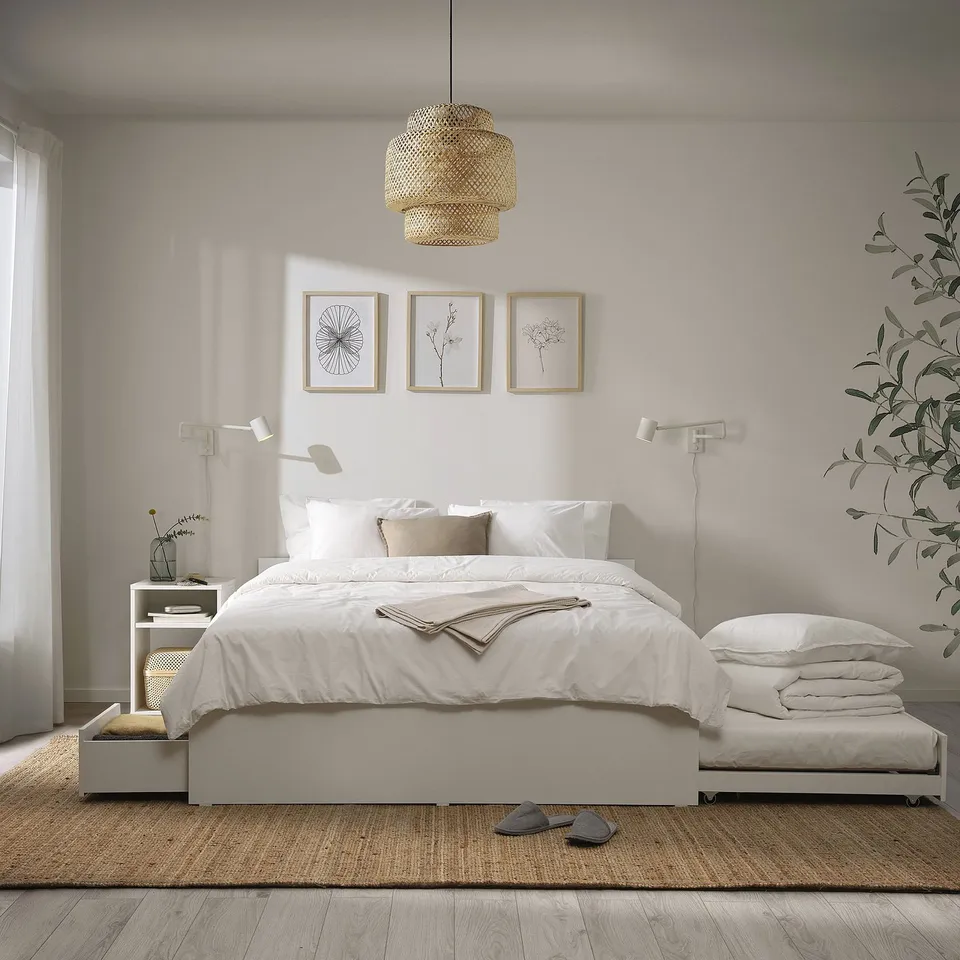 Minimalist bedroom with VIHALS bed, trundle, storage, wicker pendant, simple decor.
