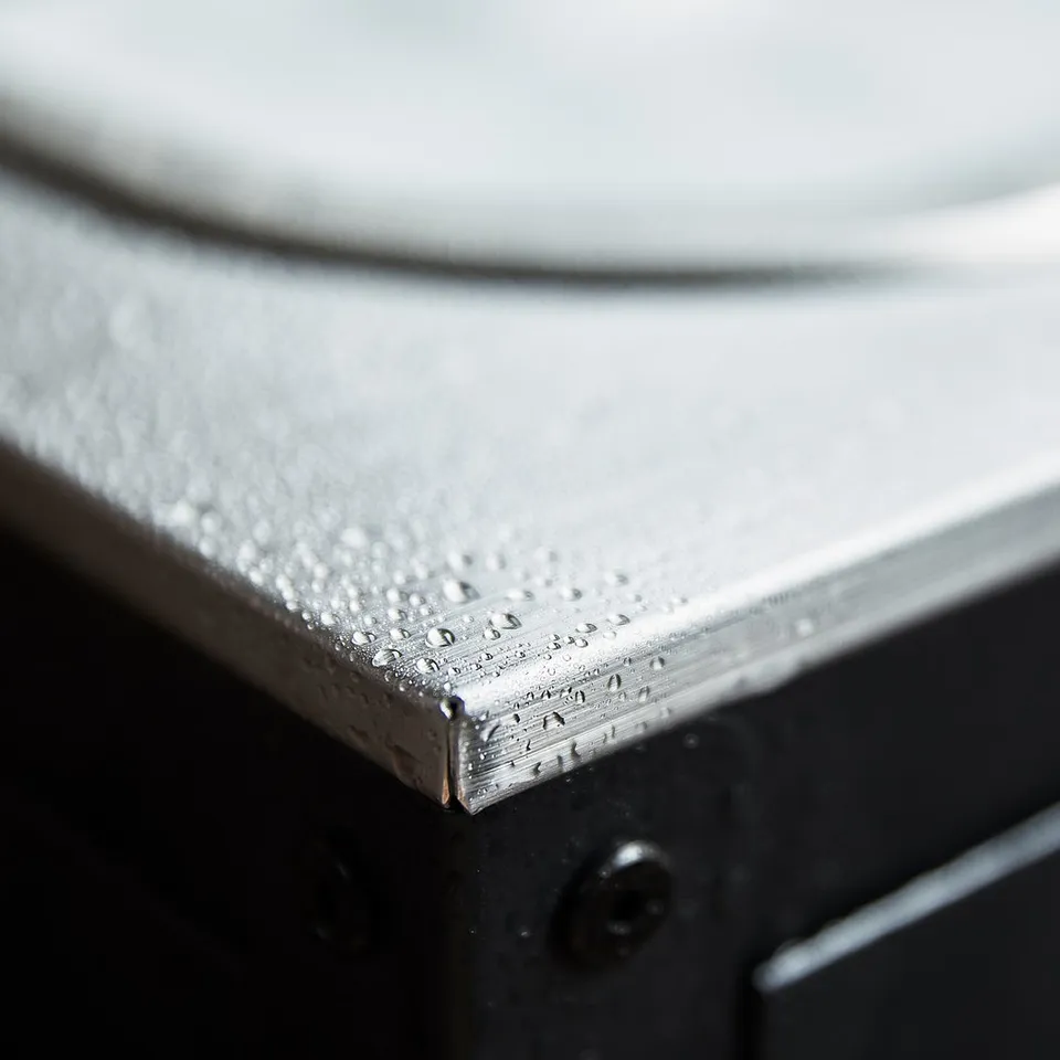 Stainless steel sink edge on black outdoor unit