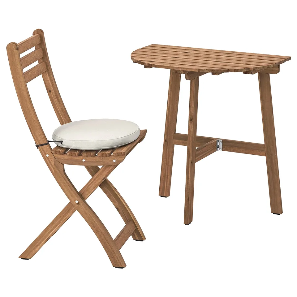 Wooden folding chair with white cushion and matching folding table, simple design, outdoor furniture set.