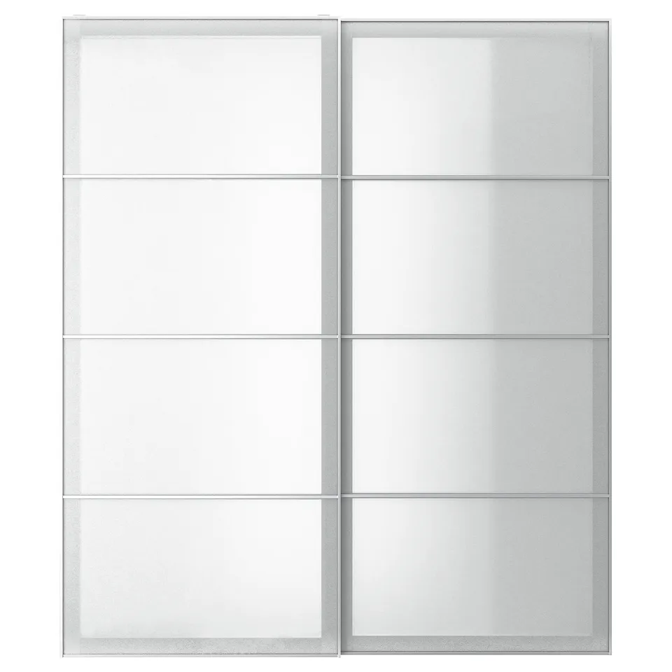 A white SVARTISDAL wardrobe with frosted glass panels. The modern design sliding doors framed in aluminium.