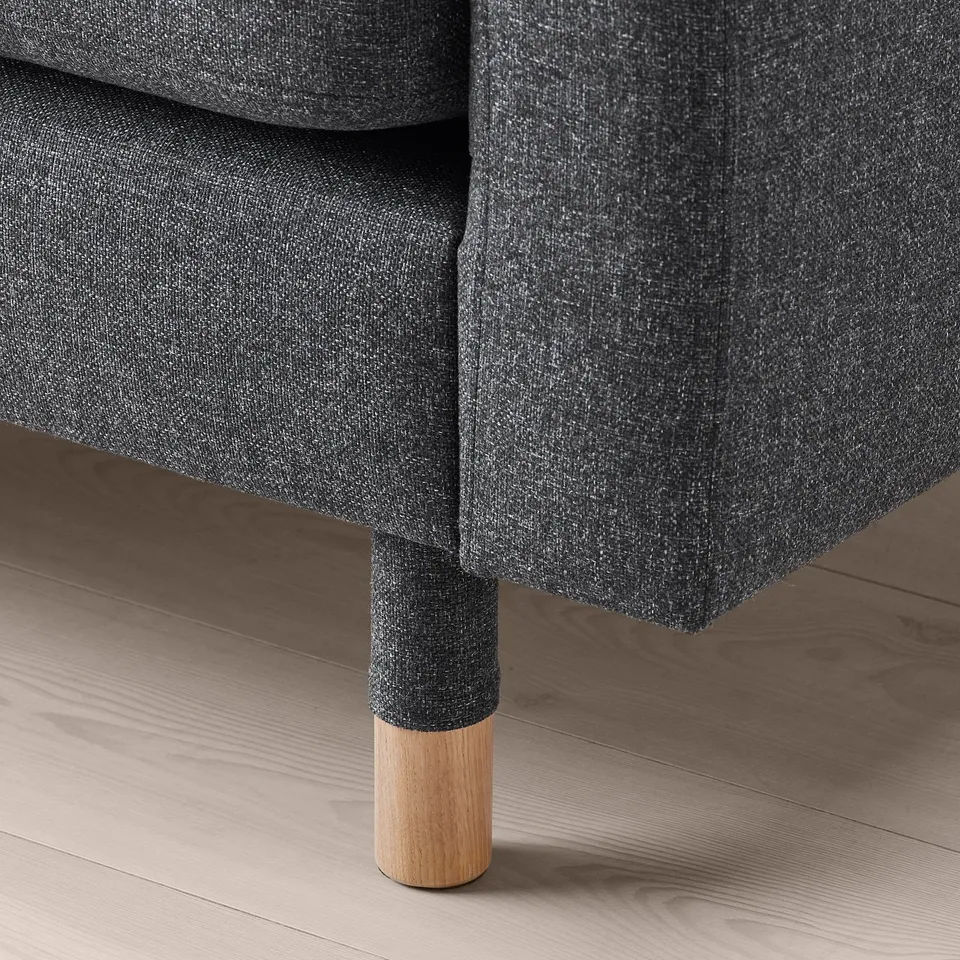 Dark grey sofa leg detail, showcasing solid wood base and sturdy construction.