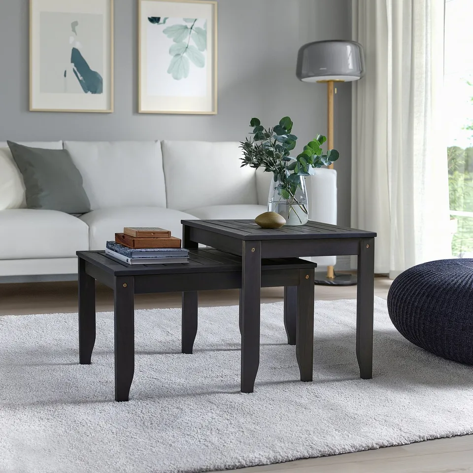 Black ÖRSKÄR acacia wood nesting tables; sleek, square design, ideal for small spaces.