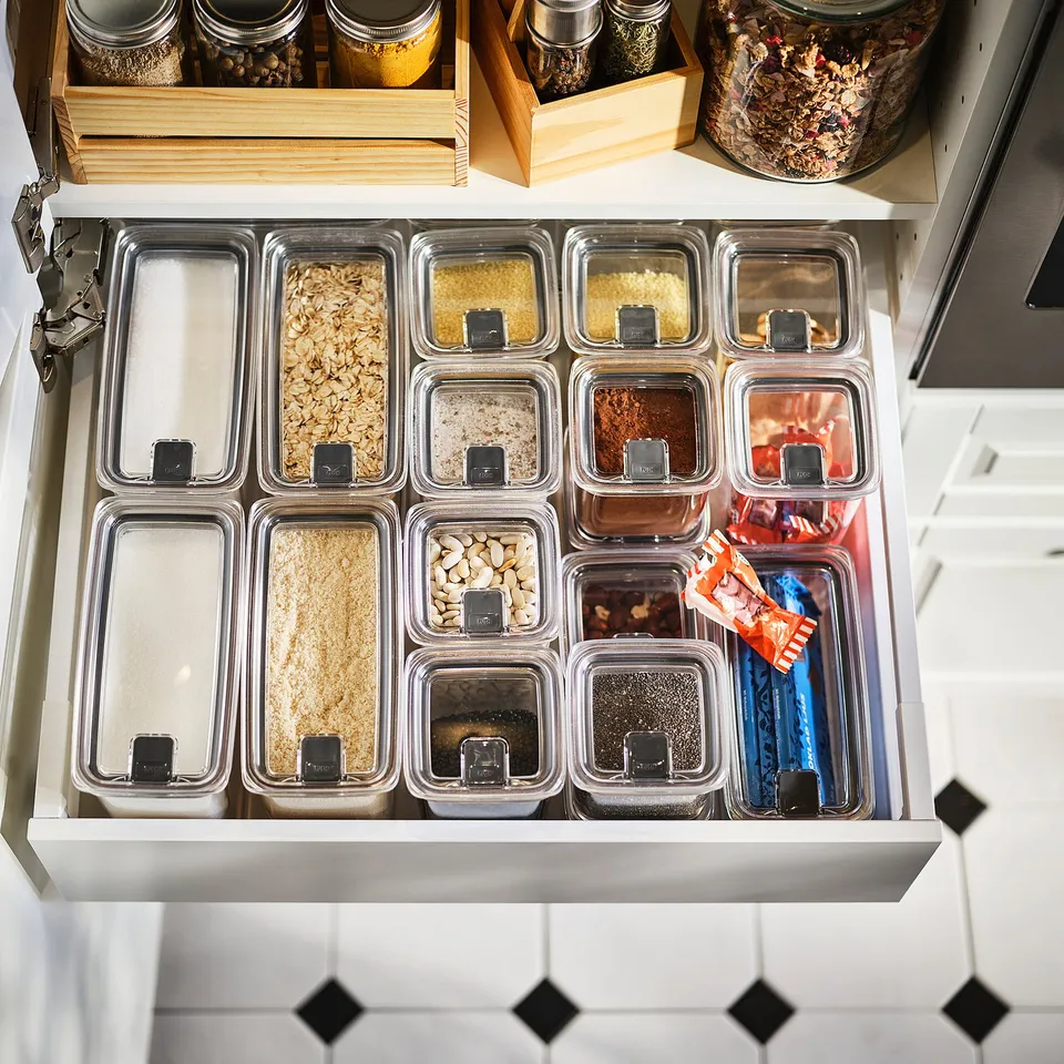 Kitchen drawer with jars of dry ingredients.