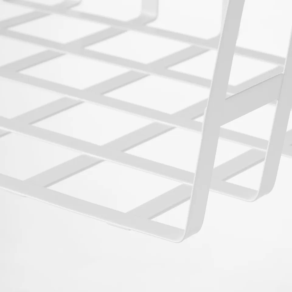 Close-up of white wire storage basket for organising kitchen items. Sturdy, powder-coated metal with grid design.