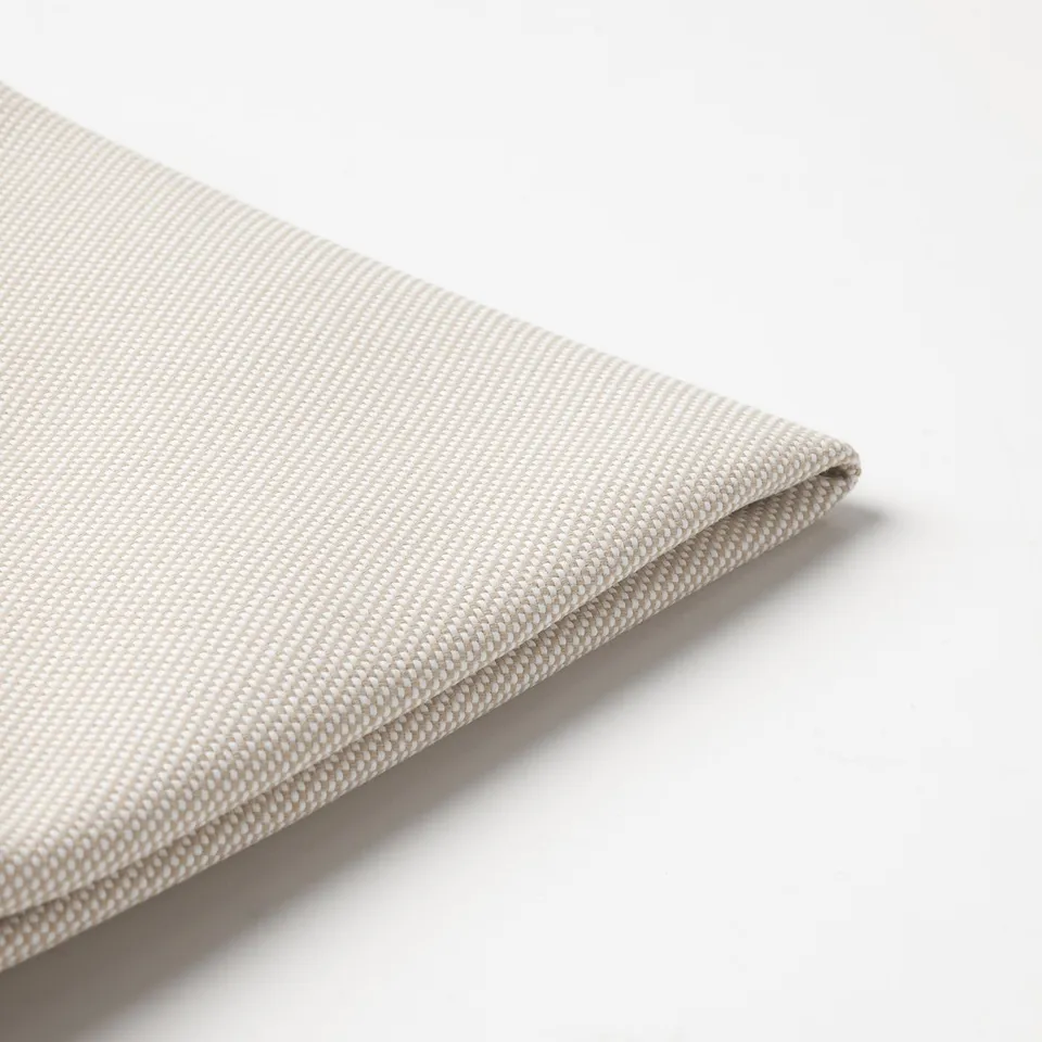Light-colored, textured fabric close-up, showcasing fine weave and smooth texture.