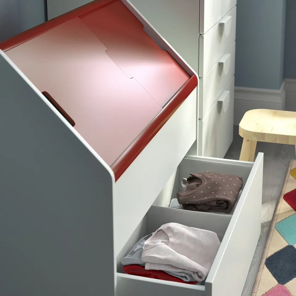 Open storage unit with red lid, grey drawer, and folded clothes inside.