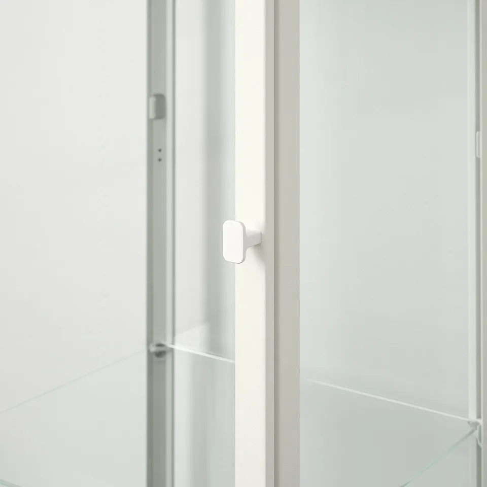Close-up of a modern, sleek glass cabinet door with minimalist handle, showcasing its high-quality design and materials.