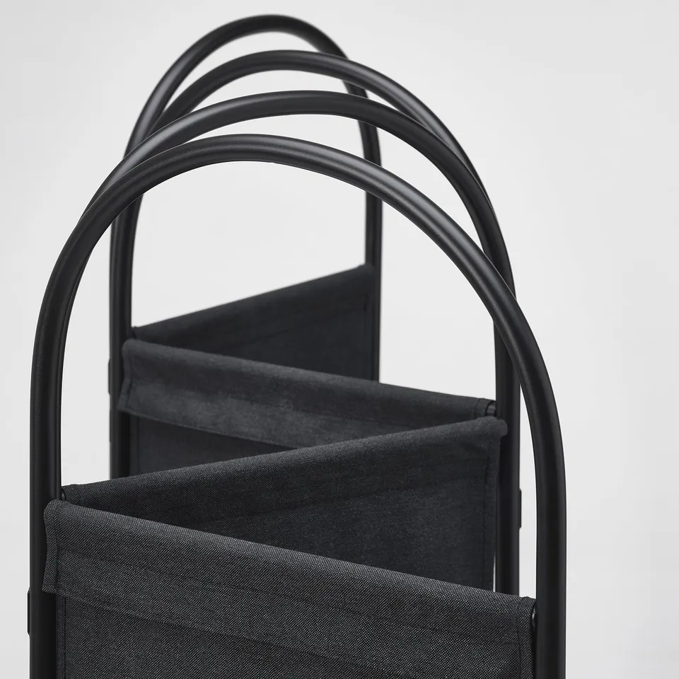 Black metal-framed room divider with sturdy, folded fabric panels. Modern, industrial design with clean lines.