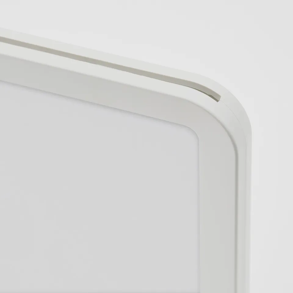 Close-up of a white plastic photo frames corner, showcasing smooth edges and sturdy design.