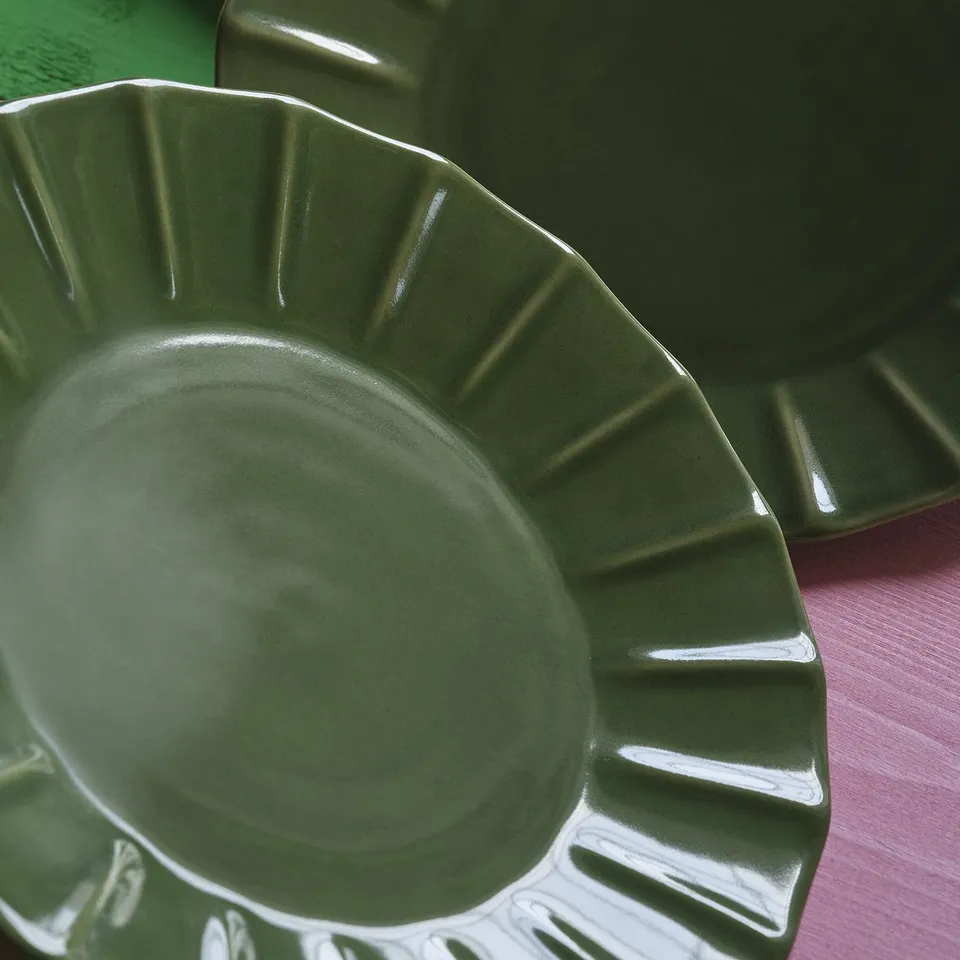 Green glazed stoneware plate with embossed edge detail, hand-crafted, elegant design.