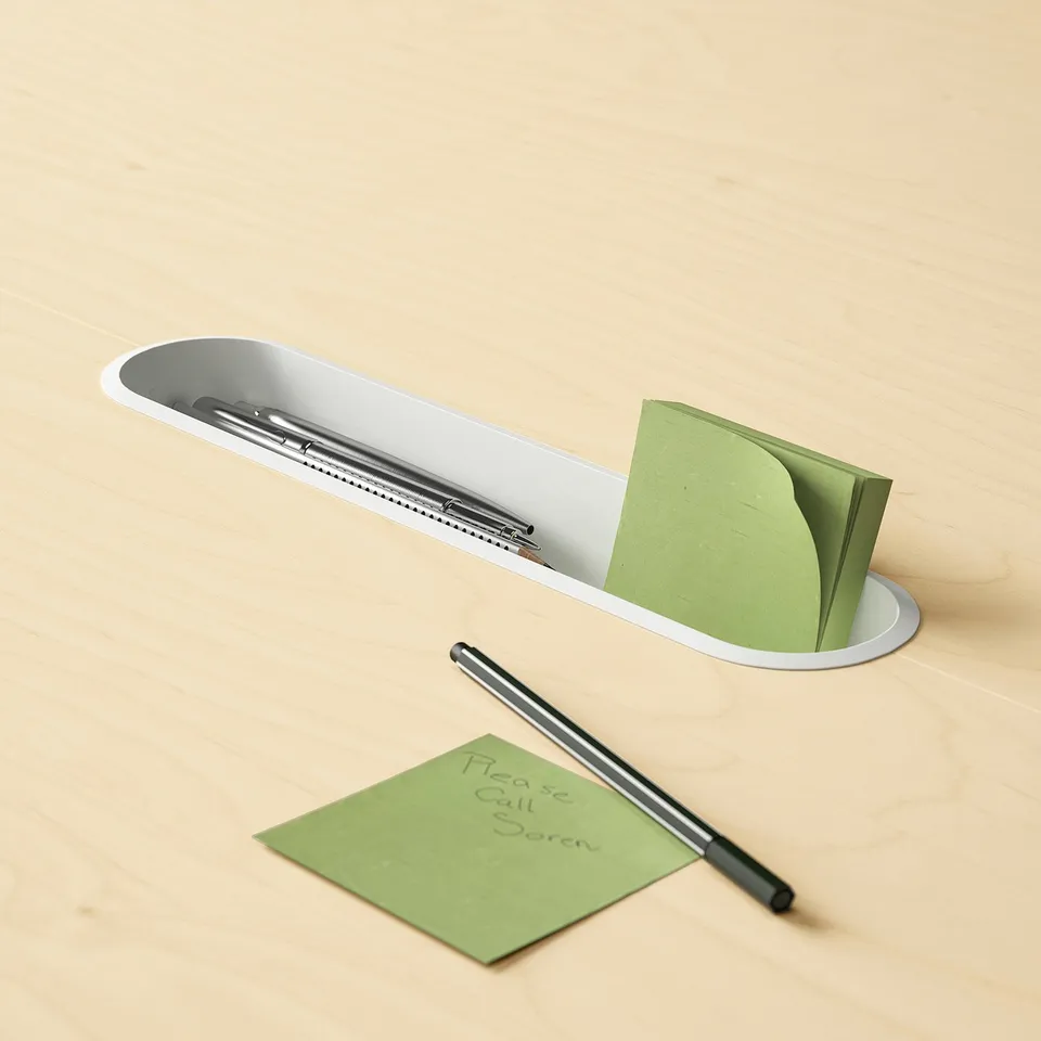 Modern desk organiser with pen and sticky notes.