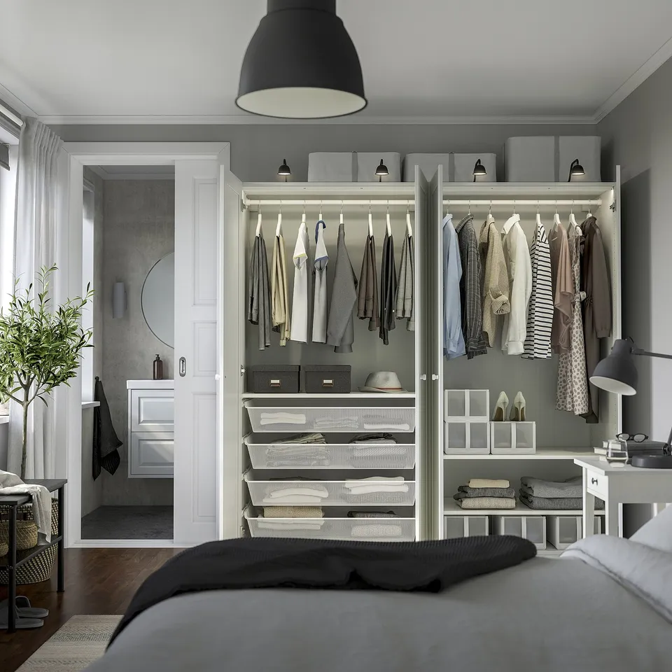 Modern bedroom with PAX wardrobe, organised clothes, lighting, & silent door closers.