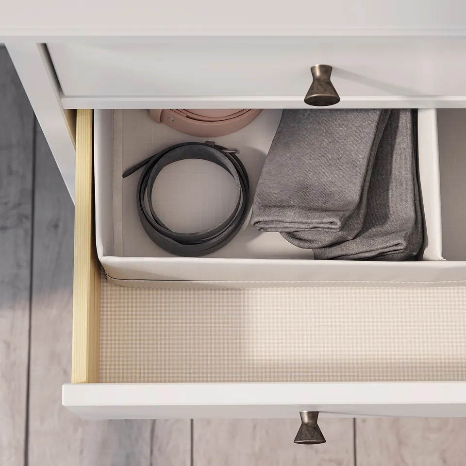 IDANÄS drawer, white, with grey belt and folded light grey sweater, organised and minimalist.
