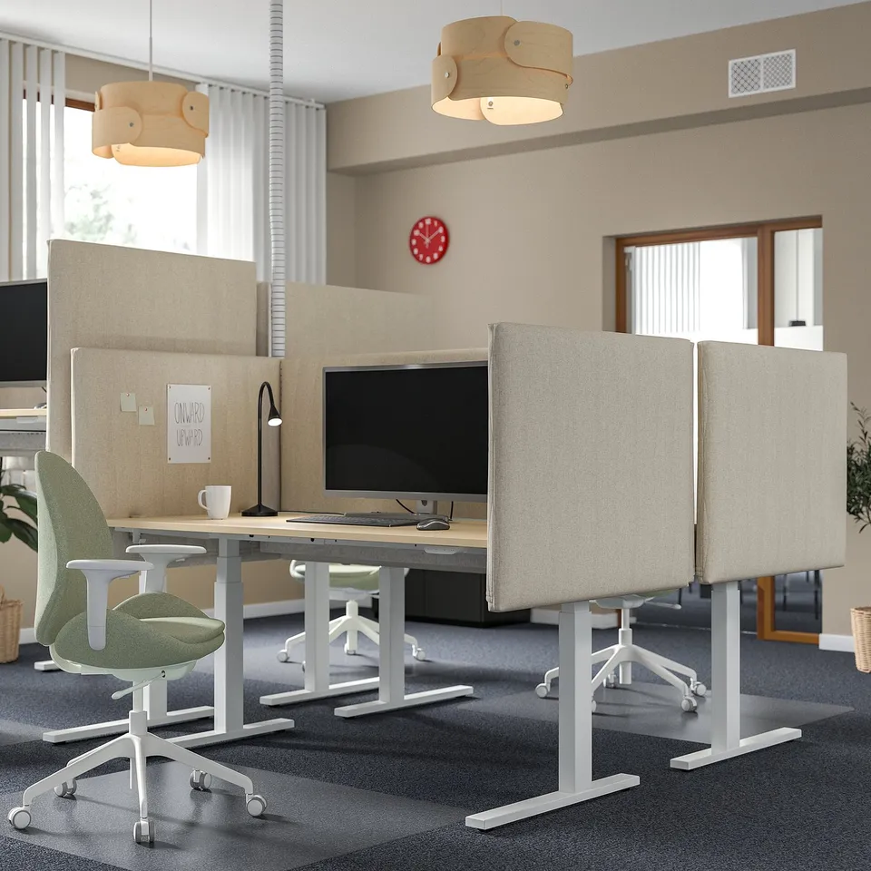 MITTZON sit-stand desks, light wood, fabric partitions, green chairs, white frames in office setting.