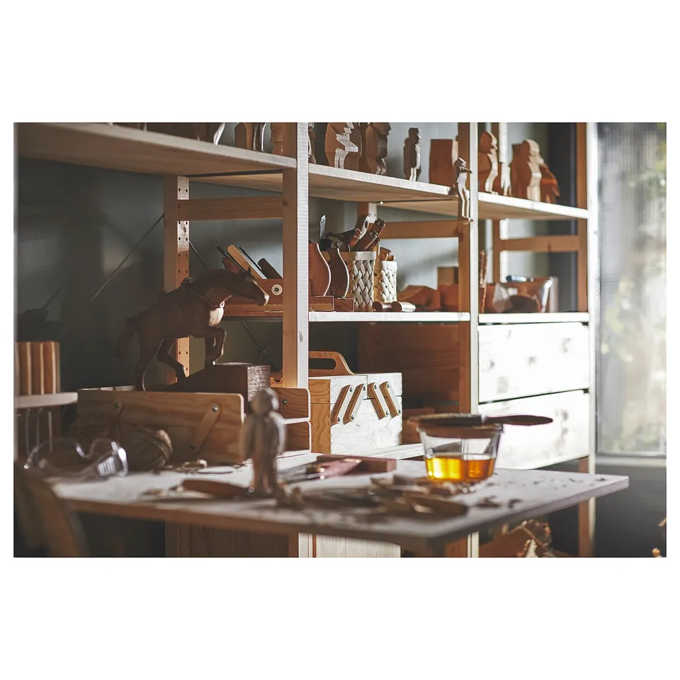 Wooden crafting table with finished horse figurine, tools, and wooden boxes, surrounded by shelves showcasing additional wooden projects and supplies.