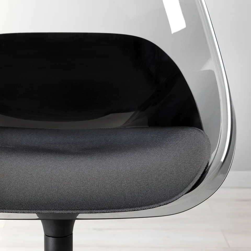 Modern swivel chair with black cushion and clear seat shell, stylish and comfortable.