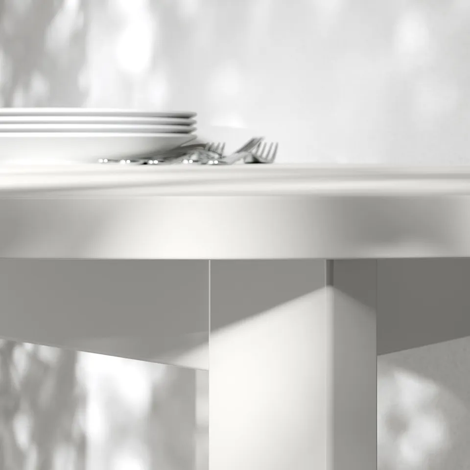 Close-up of modern round tabletop with stacked plates and utensils, showcasing sleek design and clean surface.
