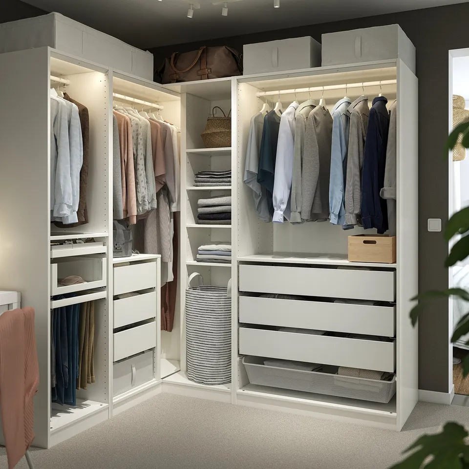 White corner wardrobe, skirt-length, with shelves, drawers, hanging & storage spaces, lit.