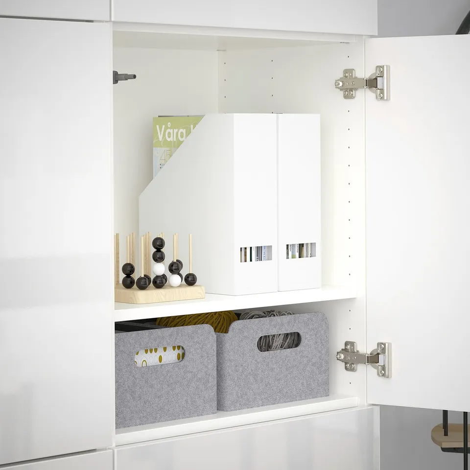White BESTÅ cabinet with adjustable shelves and soft-closing door.