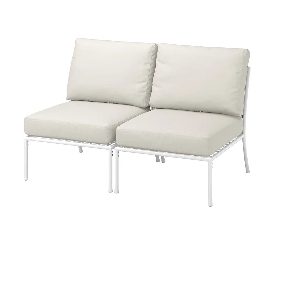Modern outdoor lounge chair with two beige cushions, white metal frame.