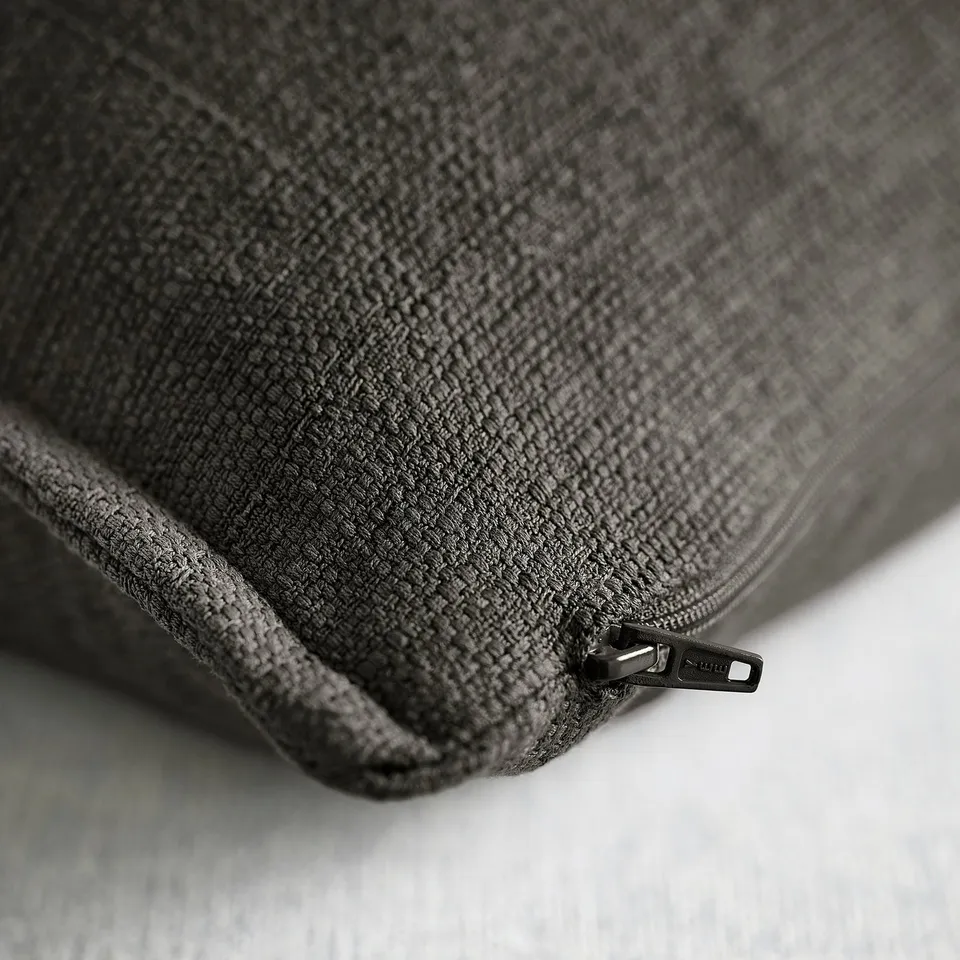 Close-up of anthracite cushion cover with durable zip.