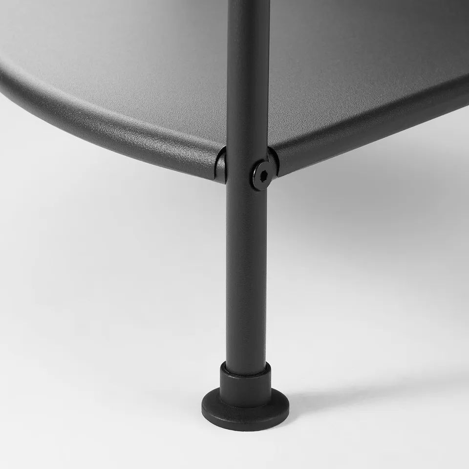 Black metal shelf, round base.