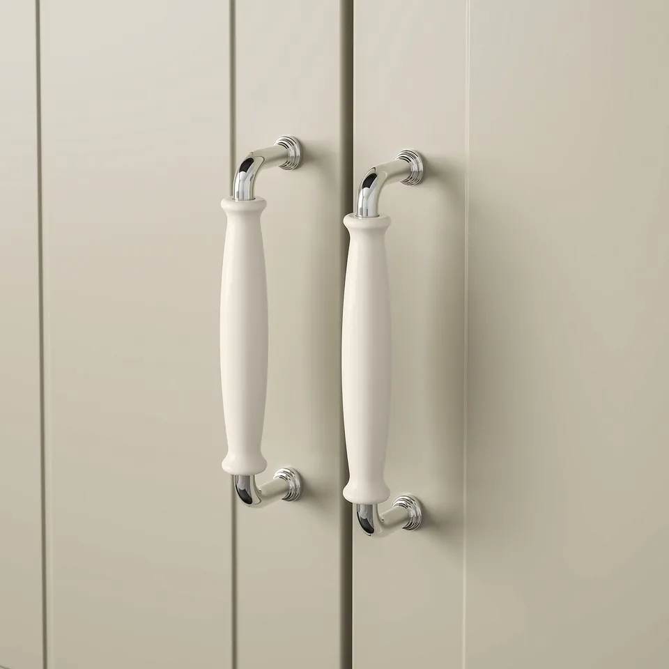 White handles with shiny chrome details on beige doors, showcasing quality finish and elegant design.