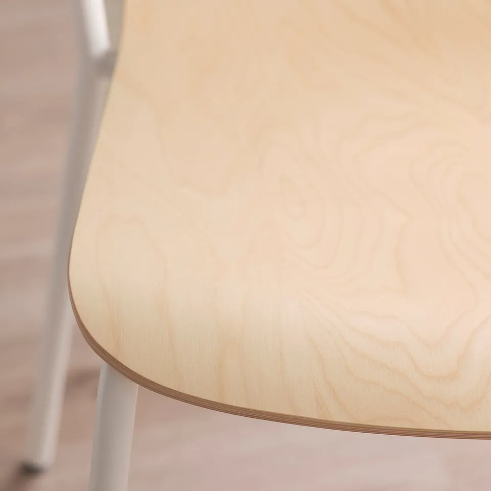 Light-colored wooden table top with visible grain and rounded edges, supported by white metal legs.