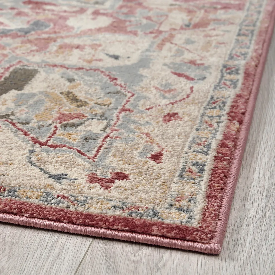 Soft, durable rug with classic oriental patterns and pastel colours on a light wooden floor.