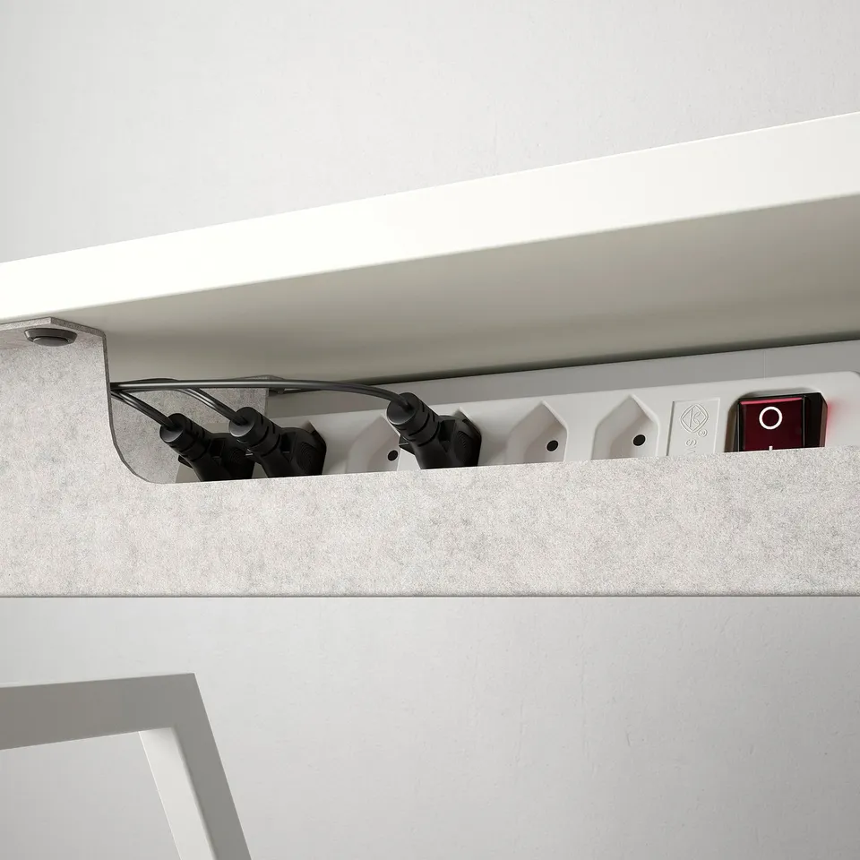 Desk with motorised lift for height adjustment. Cable management tray visible.