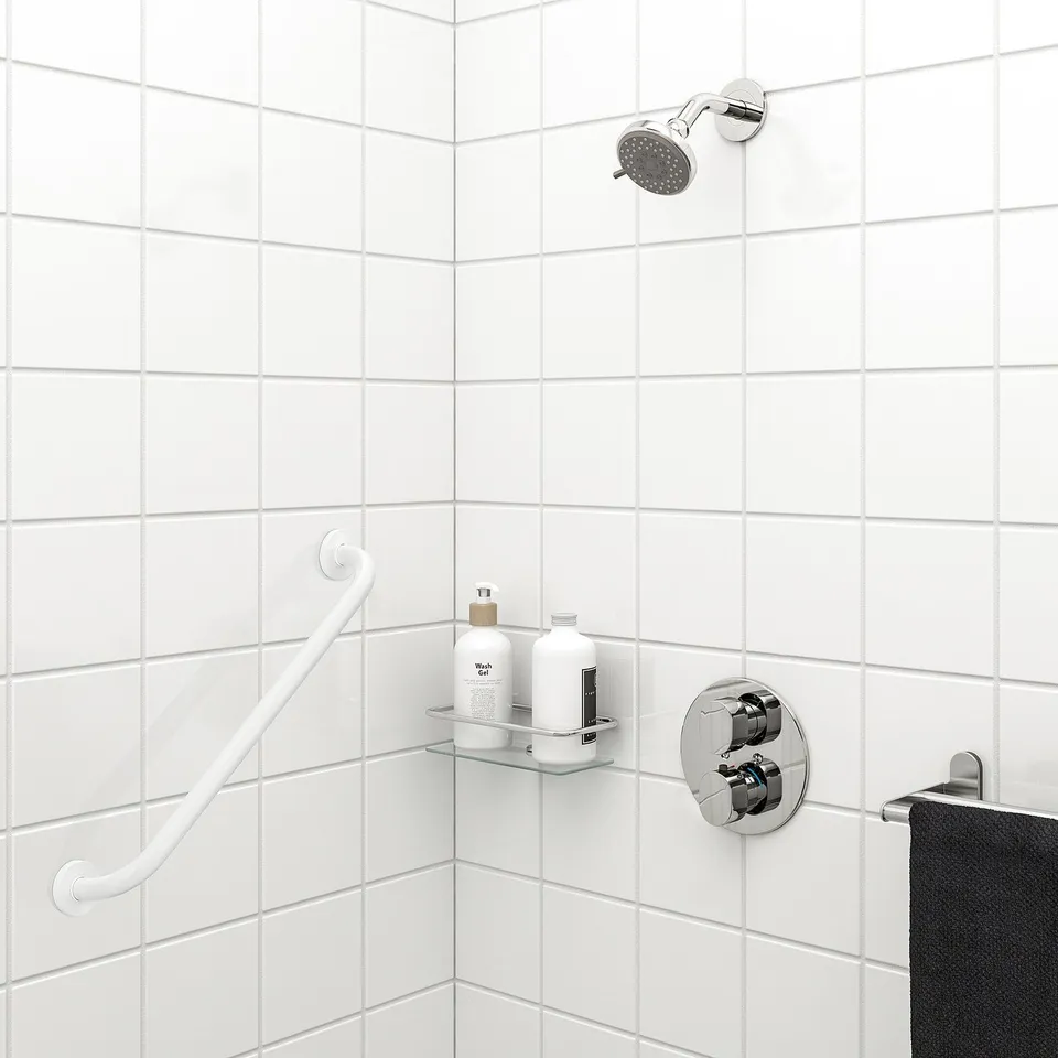White OMTÄNKSAM grab bar in bathroom for shower support.