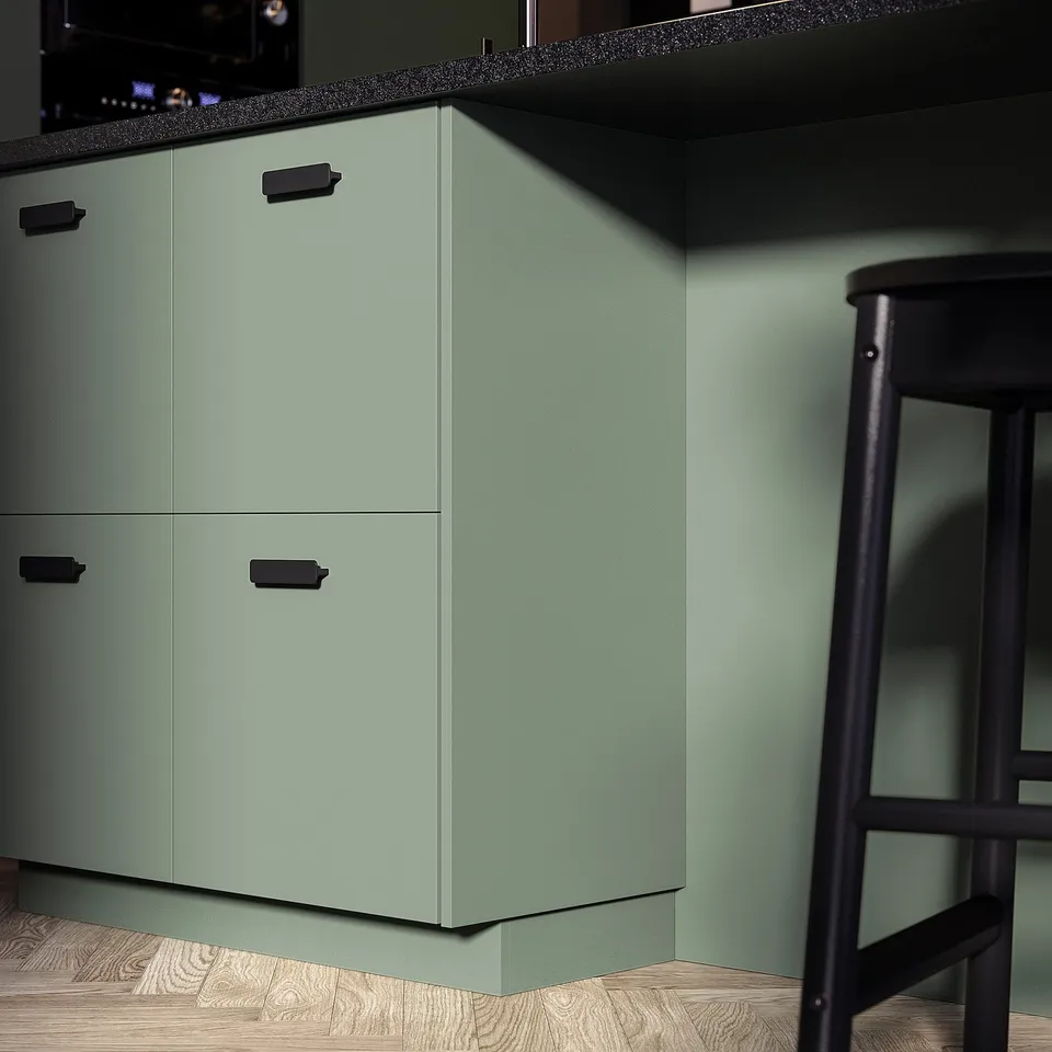 Modern green kitchen cabinets with sleek black handles and bar stool.