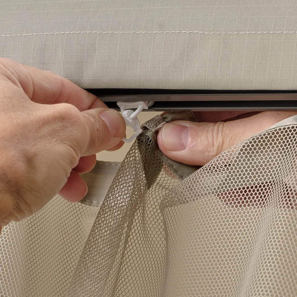 Hands assemble HIMMELSÖ mesh screen, creating additional outdoor space.