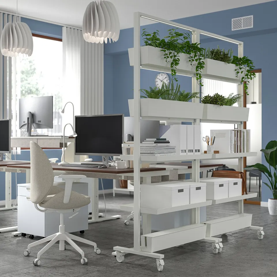 MITTZON: modern white rolling greenery divider. Tall, with multiple shelves. Plants top it. Fits office space between desks.