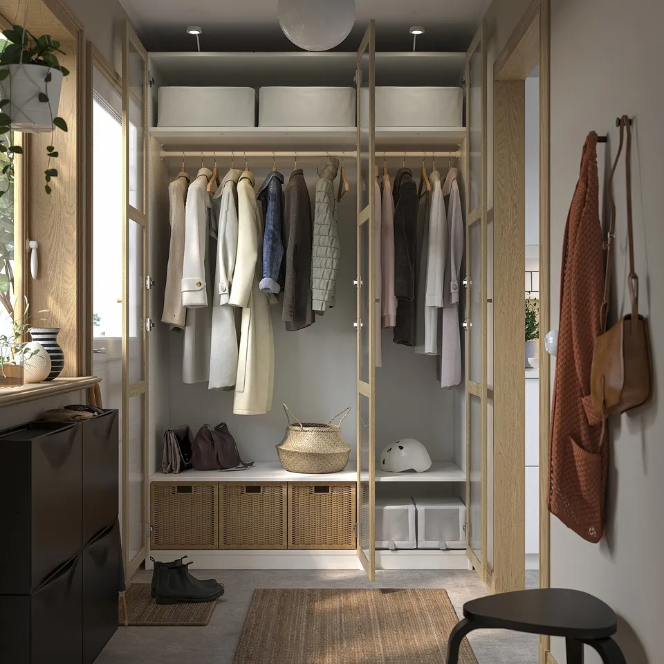 Organised closet with clothes, shelves, bins, stool, and helmet.